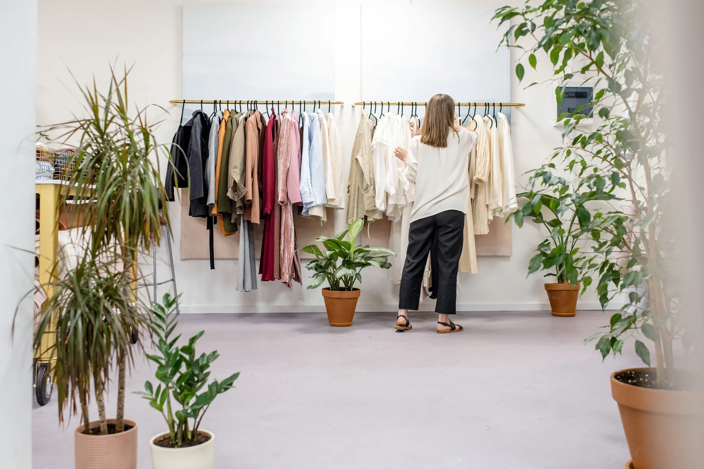 Curated clothing displayed inside a bright modern boutique
