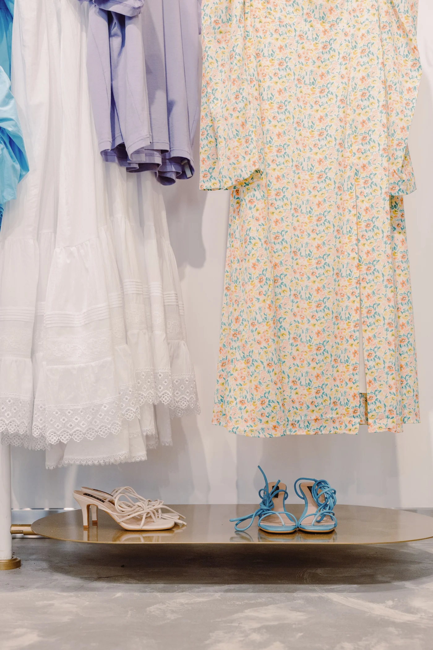 Dresses and shoes displayed inside a fashion boutique